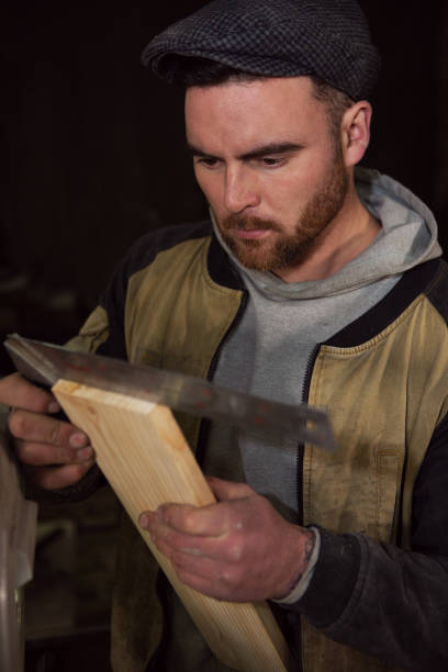 istock the man carpenter measures the wooden board 1399239963