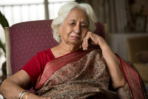 istock Thoughtful old woman sitting on chair 1399241700