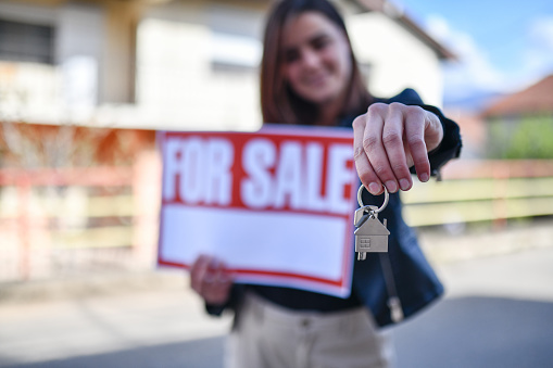 Smiling Female Selling Her House And Showing Keys