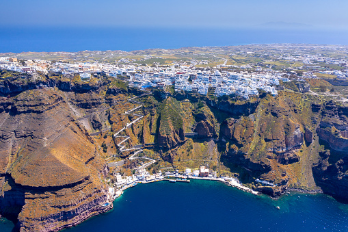 Fira town, with view of caldera, volcano and cruise ships, Santorini, Greece.