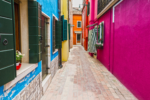 Venice, Burano narrow street multicolor houses, Italy