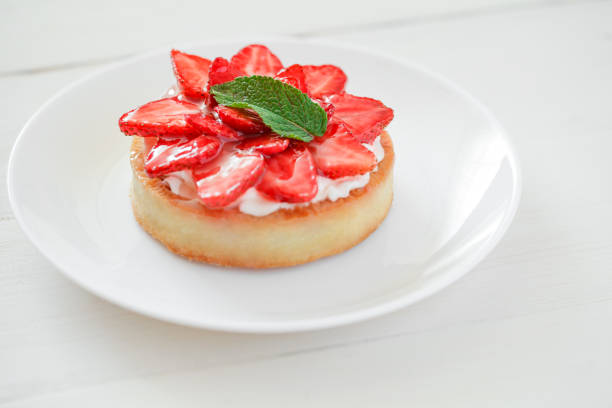 istock Strawberry tart, cake, on white wooden board background, selective focus. 1399248385