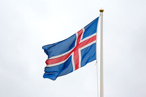 flag of iceland in the wind against a light sky