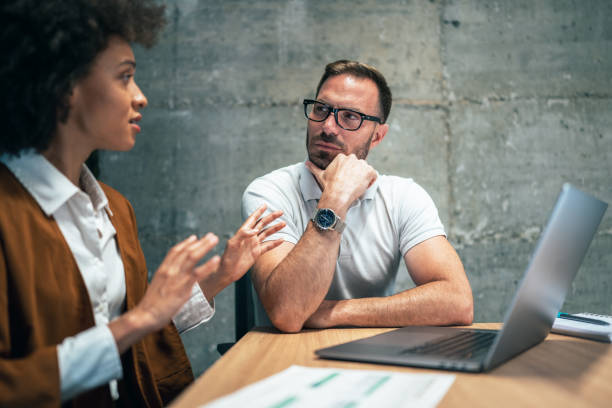 istock Two business people working together in office 1399249514