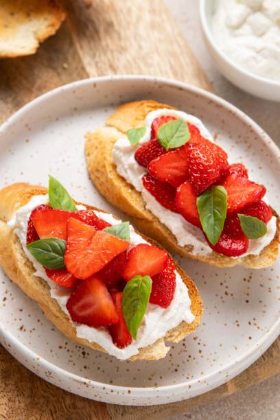 istock Bruschetta with goat cheese or ricotta witn strawberry and basil. Appetizer with berries. Summer healthy breakfast. Selective focus. 1399251097