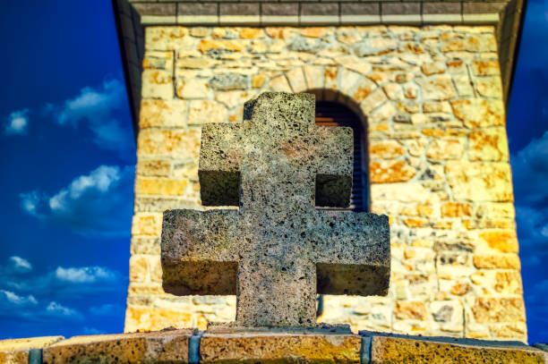 Traditional concrete cross at entrance in church yard.
