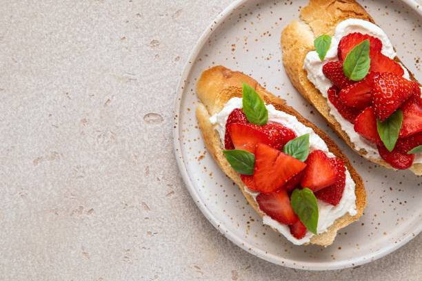 istock Bruschetta with goat cheese or ricotta witn strawberry and basil. Appetizer with berries. Summer healthy breakfast. Top view, copy spase. 1399252887
