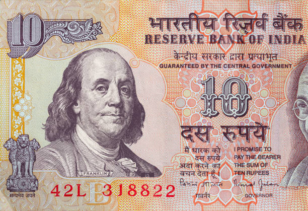 istock old 10 Indian rupee obverse with superimposed Benjamin Franklin from 100 dollar banknote 1399257552