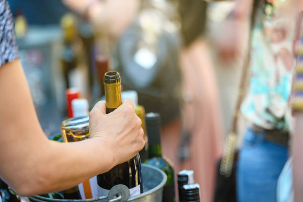 istock Picking up a wine bottle from an ice bucket 1399258375