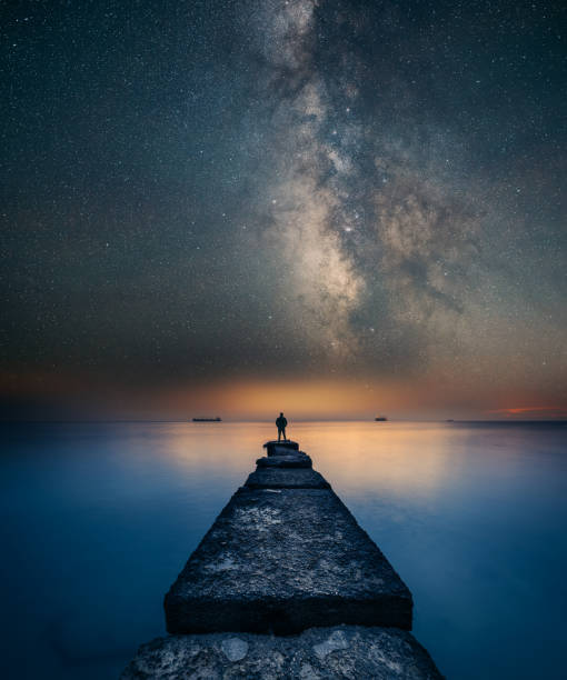 istock Man standing under the Milky Way Landscape 1399259613