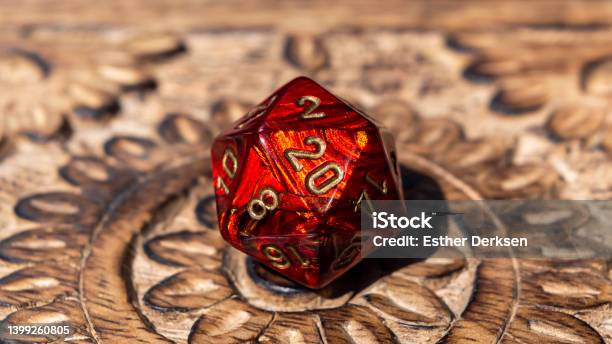 Closeup Image Of A Red D20 On A Wooden Surface Stock Photo - Download Image Now - Dragon, Dungeon, Dice