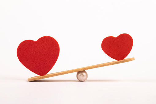 Seesaw with hearts isolated on white background