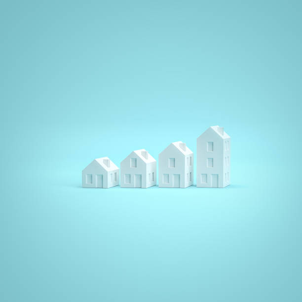 Which size of house can you afford? Concept shot: four differently sized models of houses on a turquoise blue background. Copy space available - can be used horizontally and vertically. stock photo