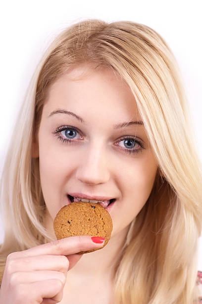 istock Young women eating cookie 139926659