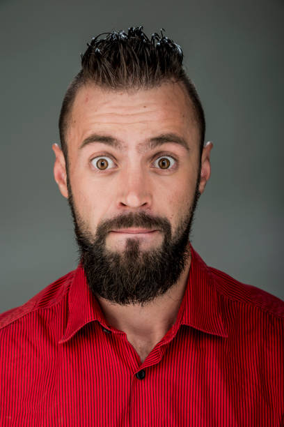 istock funny guy with a beard in a red shirt close-up shows different emotions. cheerful kind sad surprised satisfied range of emotions 1399269710
