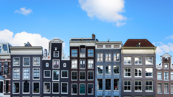 Amsterdam, Netherlands. Views of houses and clear blue skies. Famous Danish houses. Cityscape in the daytime. Travel photography.