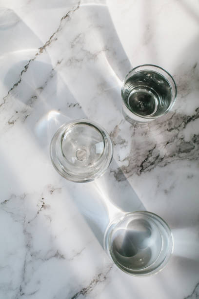 istock Sunlight through glass of water make light and shadow make a beautiful pattern by refraction of light on white background. 1399279647