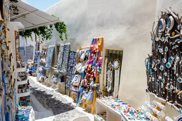 Photo of Walking in the streets of Santorini in Greece. Outdoor souvenir shop.