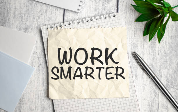 istock WORK SMARTER word on sticker on notepad with pen and calculator 1399281669