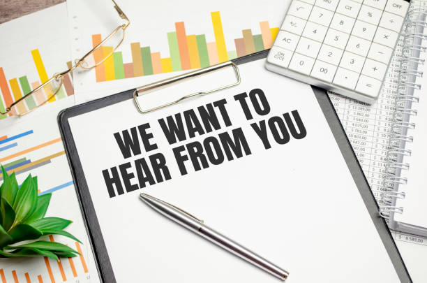 Text we want to hear from you on folder and charts, glasses and pen stock photo