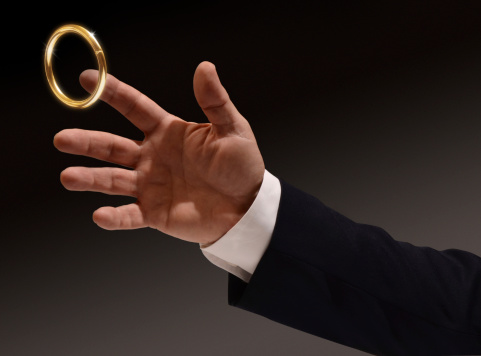 Business man's hand reaching for the brass ring