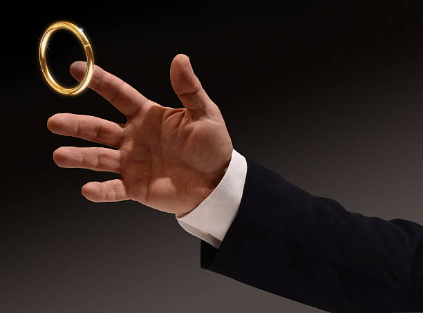 Brass ring being caught by man stock photo
