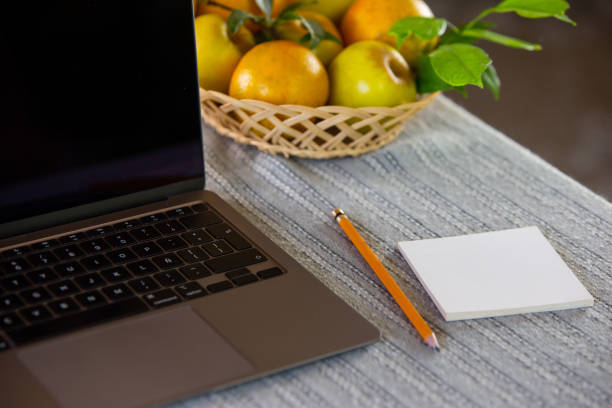 Work station in home, with fruit and water bottle.