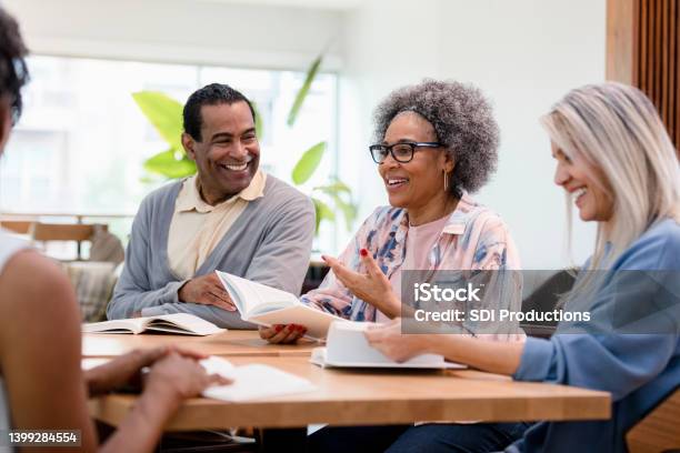 Group Member Discusses Her Review Of The Book Stock Photo - Download Image Now - Senior Adult, Meeting, Book Club