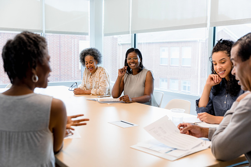 Happy diverse different aged team of businesspeople, best employees, interns and mentor office business portrait. Multiethnic group of coworkers meeting at table, looking at camera, smiling