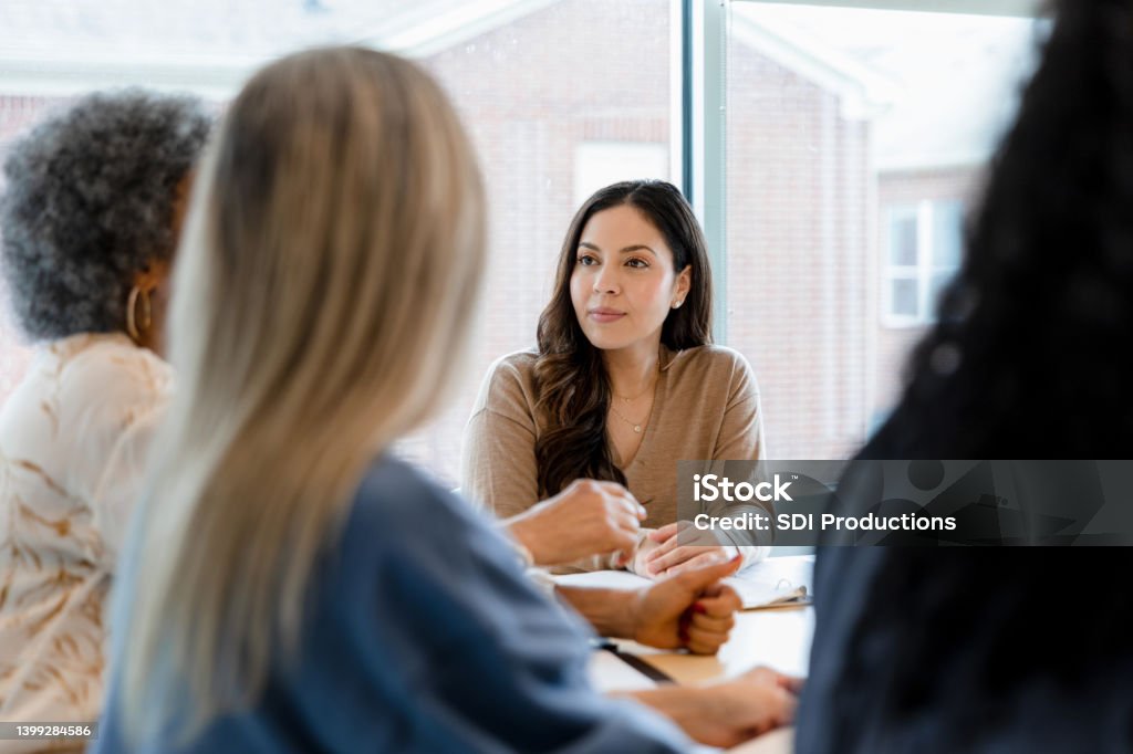 Adult women gather together to brainstorm The group of adult women gather together to brainstorm fundraising ideas for the elementary school. Businesswoman Stock Photo