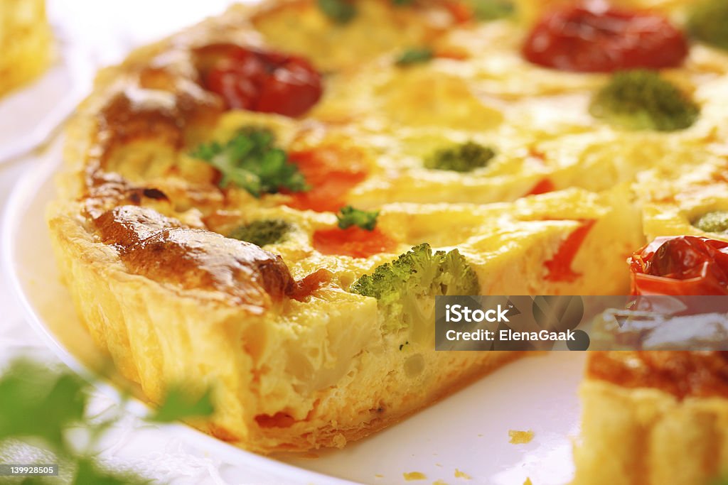 Quiche with cheese and an assortment of vegetables cheese quiche with broccoli, cauliflower, carrots and tomatoes Cauliflower Stock Photo