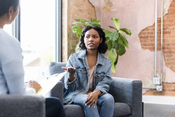 istock Teenage girl gestures while talking to unrecognizable counselor 1399285436