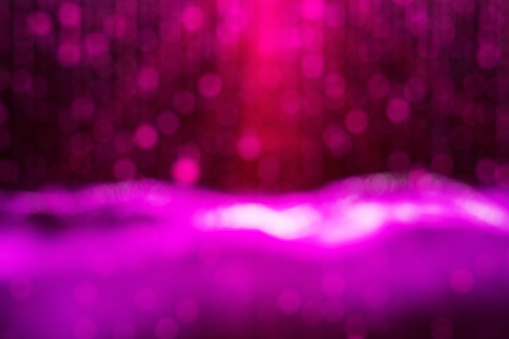 blurred theatre show with purple light on stage, abstract image of concert lighting