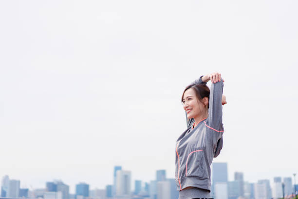 istock Young woman stretching outdoors with a smile 1399287403