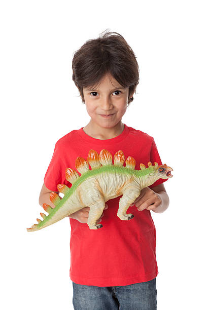 istock Little boy is showing his toy dinosaur 139929032