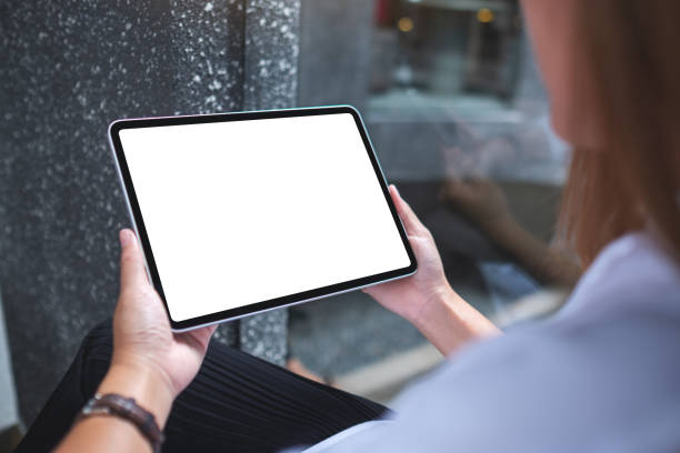 istock Mockup image of a woman holding digital tablet with blank white desktop screen 1399295233