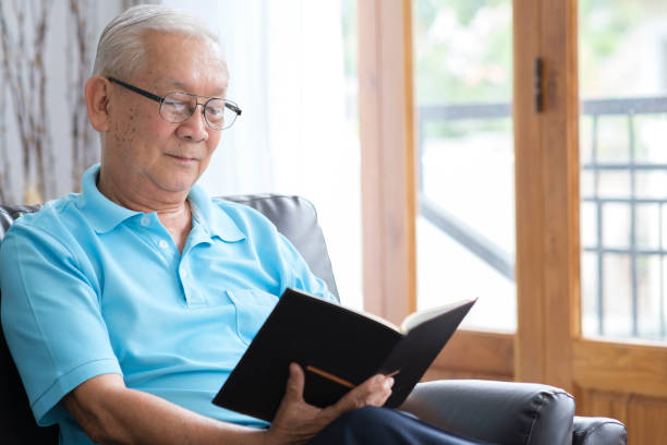 istock Senior man reading book and stay alone at home. 1399298114