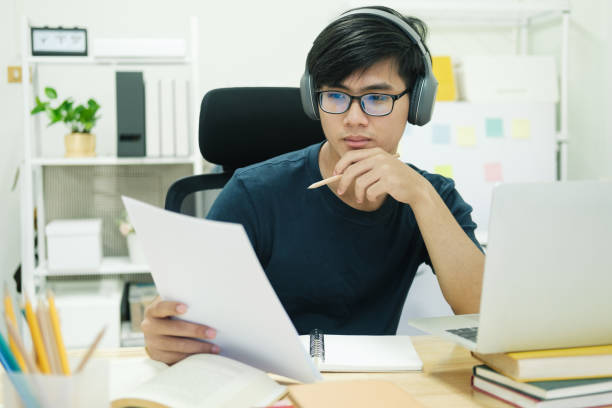 istock Young man study in front of the laptop computer at home 1399298368