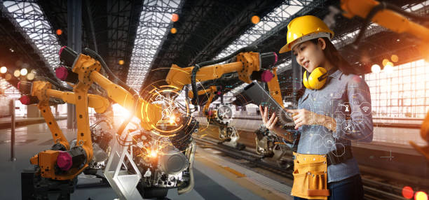istock Women engineer check and control welding robotic automatic arms machine in intelligent factory automotive industrial with monitoring software connected to network. Digital manufacturing. Industry 4.0 1399298427