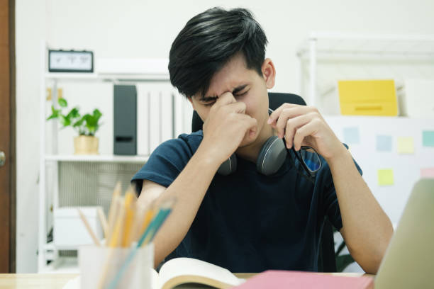 istock Exhausted businessman rubbing eyes while working at home. 1399298475