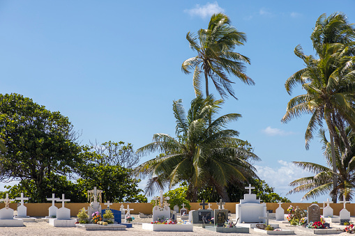 The cemetery in the village of Rotoava at Fakarava atoll, French Polynesia on 5th May 2022. Catholic tradition and burial is followed on French Polynesian islands like Fakarava.