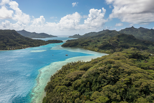 A deep, crystal-clear lagoon surrounds the two islands that comprise Huahine, while magnificent bays and white-sand beaches add drama to the travel experience.