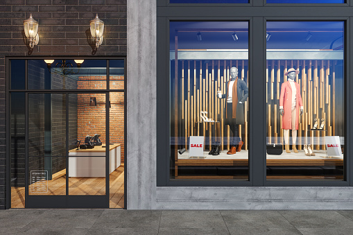 Facade Of Clothing Store With Mannequins, Clothes And Shoes Displaying In Showcase