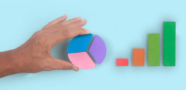 istock Business connecting piece of multi colored pie chart in  hand 1399304056