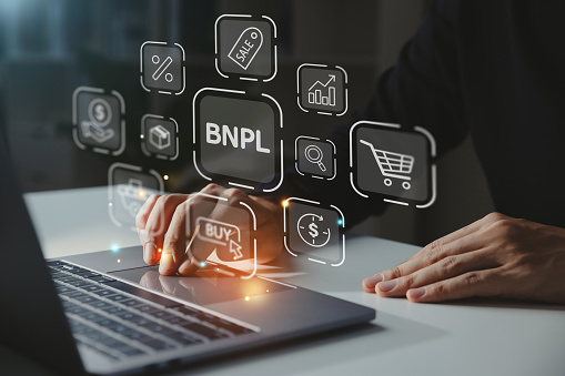 BNPL-Buy Now Pay Later shopping online icon concept, Young businessman using laptop with BNPL icon.
