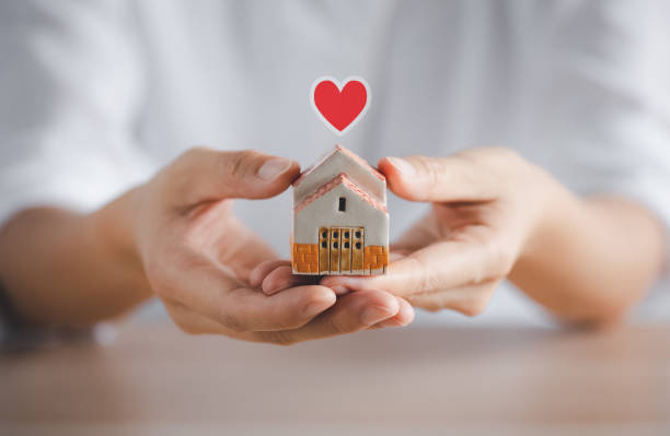 istock woman holding home model on hands 1399307014