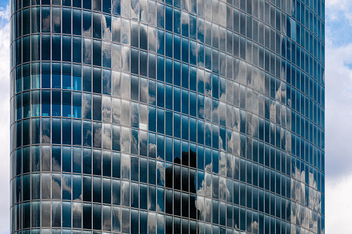 Reflections of clouds on glass  windows of building