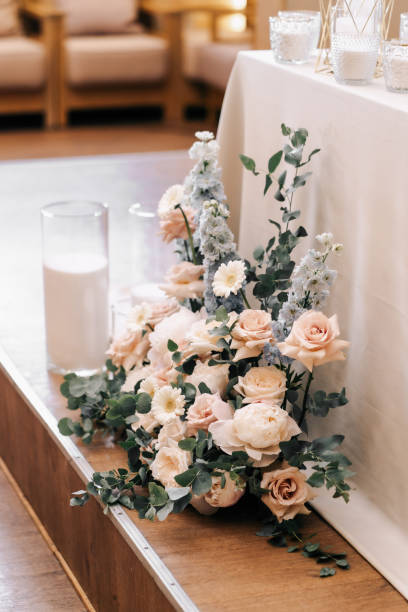 istock Wedding decor. Composition of flowers, roses, eucalyptus, chamomile orchids arranged in a bouquet that decorates the holiday table 1399309454