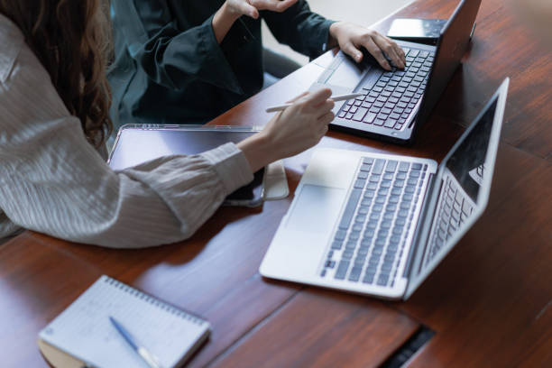istock Co-workers Discussion while using the laptop stock photo 1399310547