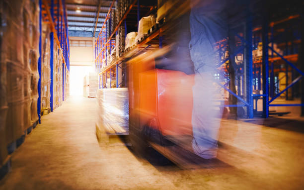 istock Blur Motion of Workers Driving Forklift Unloading Cargo Pallets in The Warehouse. Shipping Warehouse. Delivery Service Shipment Boxes. Supply Chain Goods. Warehouse Cargo Logistics Transport. 1399312882